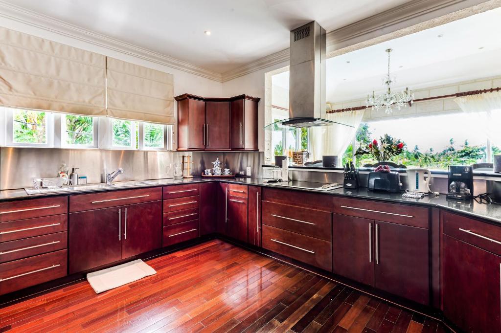a large kitchen with wooden cabinets and wooden floors at The Palms Resort in Saint James