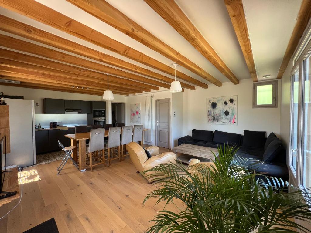 a living room with a couch and a table at Villa au lac du Salagou - 10 pers in Octon