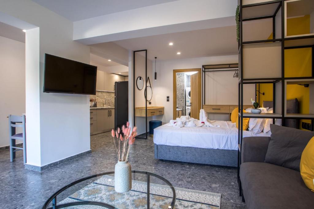 een woonkamer met een bed en een glazen tafel bij GM Apartments-Rhodes Luxury Living in Kalithies