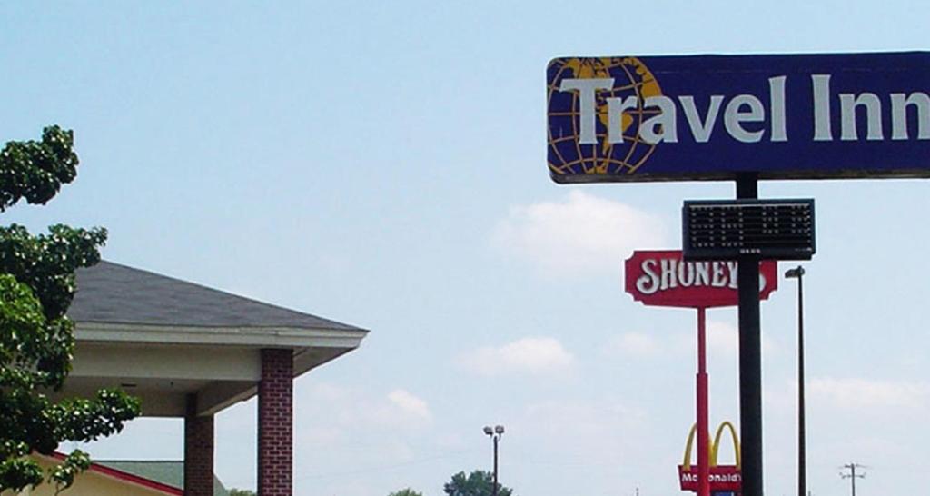 a sign for a travel inn in front of a store at Travel Inn - Lugoff in Lugoff