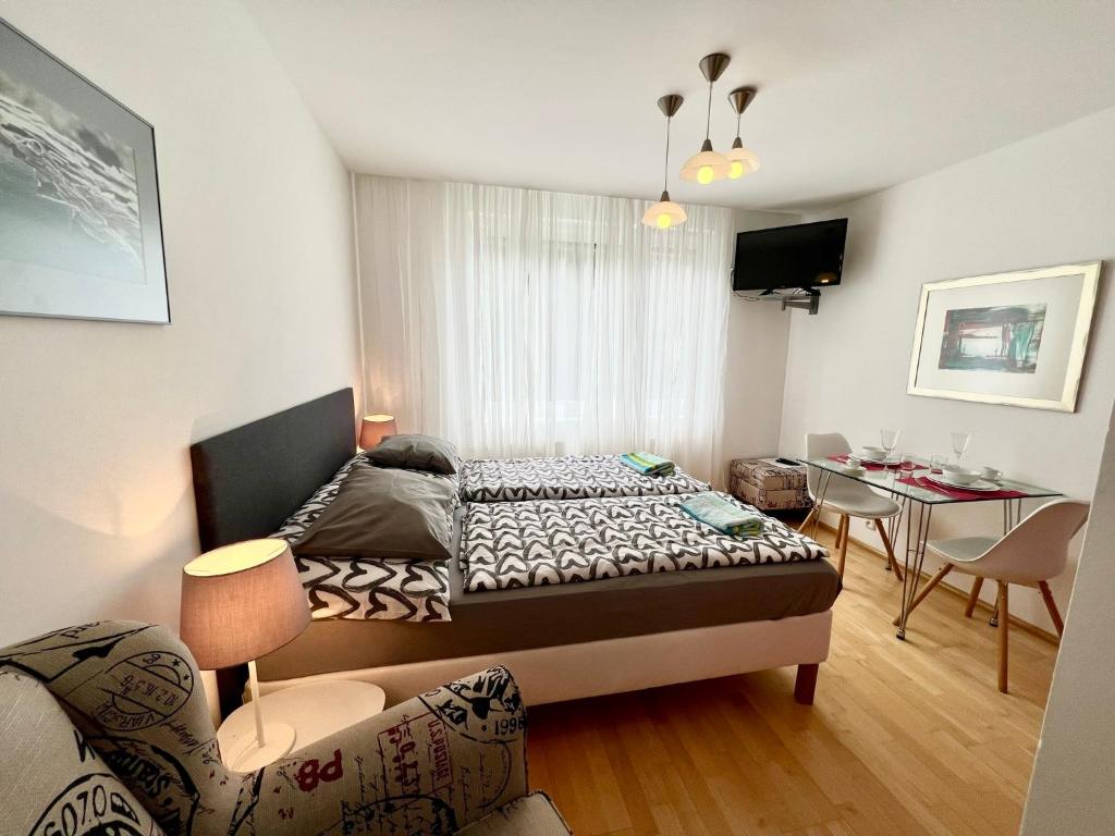 a living room with a bed and a table at Apartmán u lesa, Srní 119 in Srní
