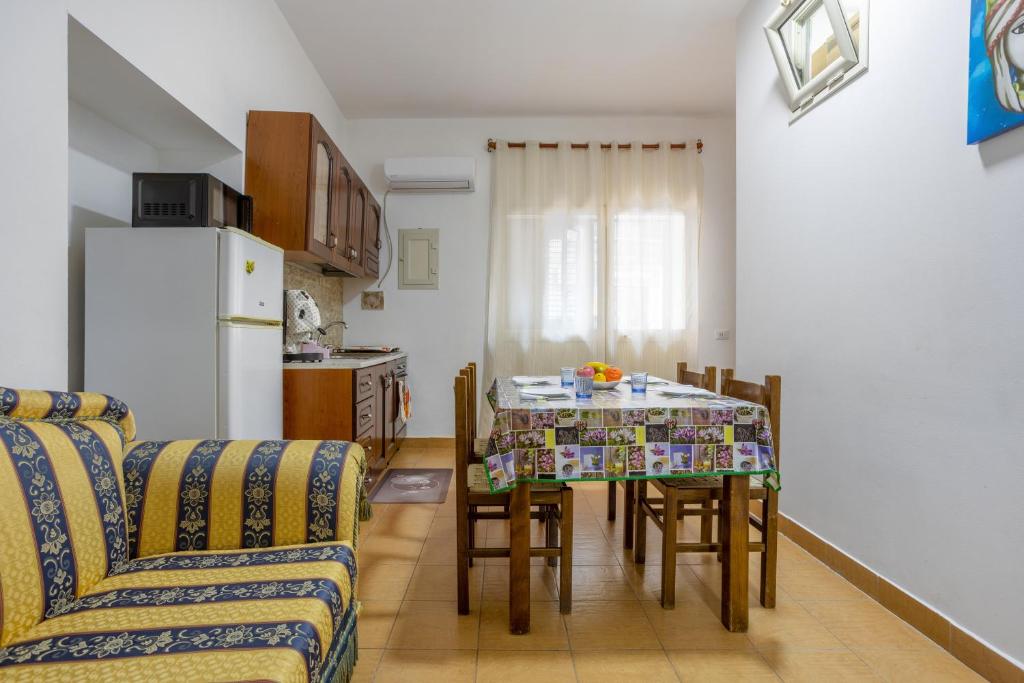 a kitchen and dining room with a table and chairs at Casa Vacanze Cappuccini in Palermo