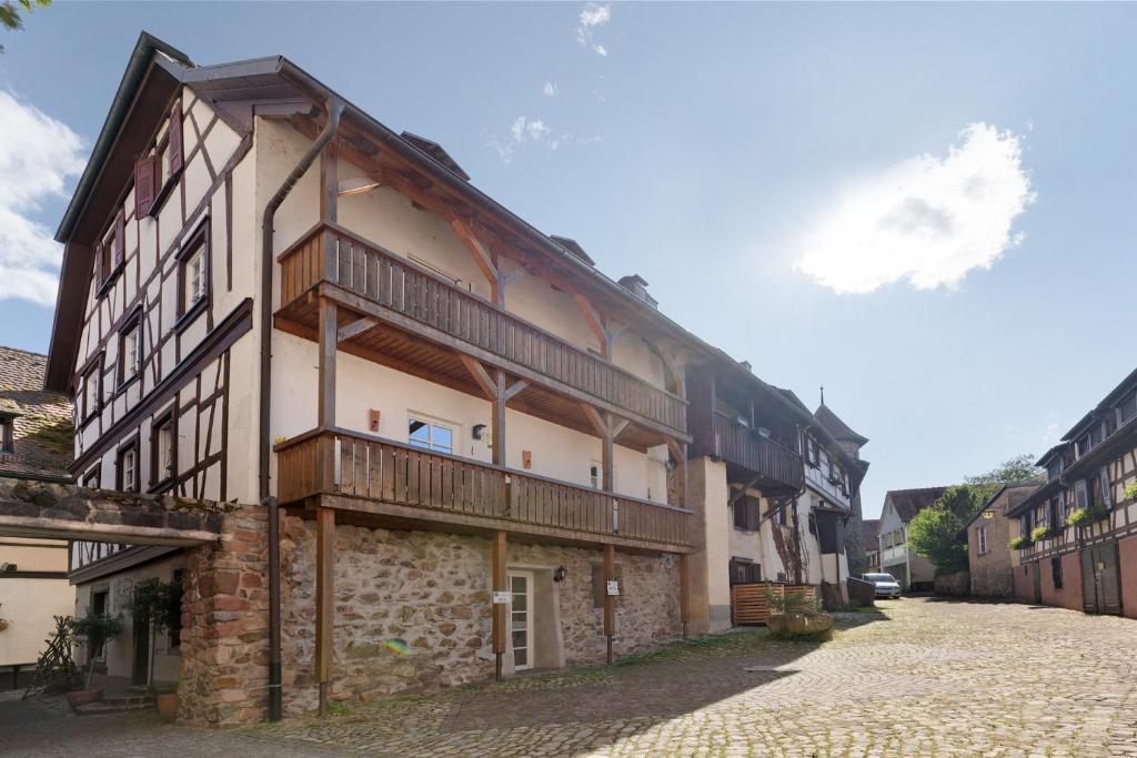a large building with wooden balconies on a street at Casa Stadtblick in Gengenbach