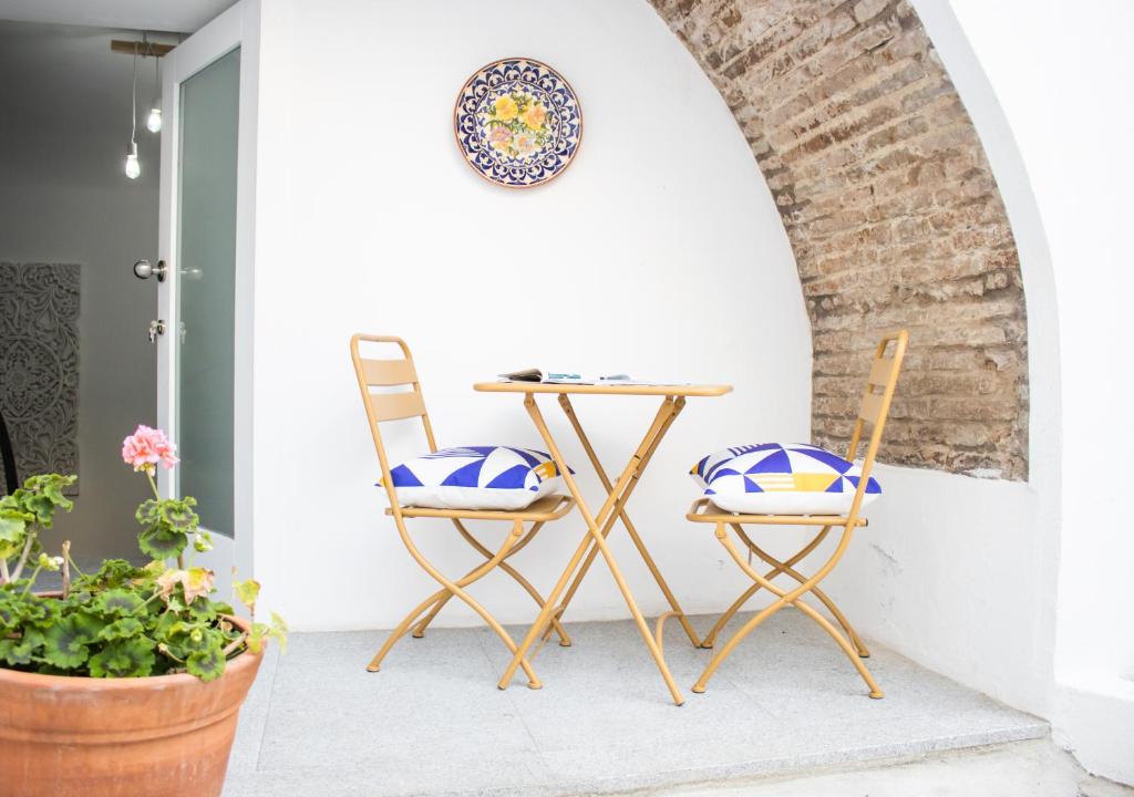 a table and two chairs on a porch at Casa do Pátio- Parking included in Évora
