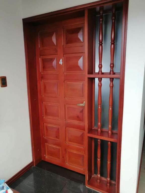 a wooden closet with a wooden door at Hotel Boutique Babilonia Manizales in Manizales