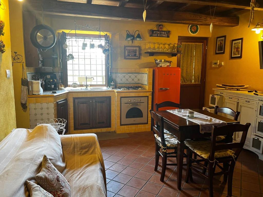 a kitchen with a table and a dining room at La Maggiorana in Tagliacozzo