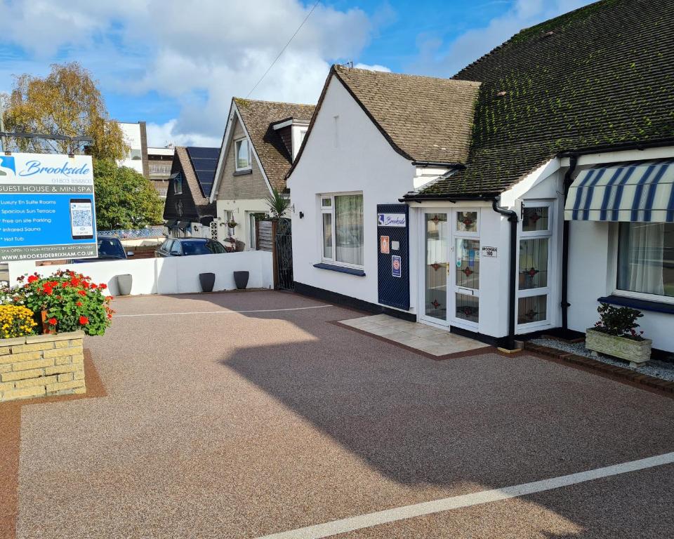 a house with a driveway in front of it at Brookside Guest House & Mini Spa in Brixham