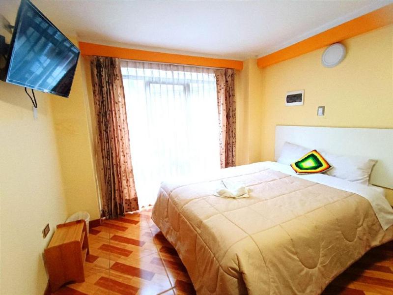 Postel nebo postele na pokoji v ubytování SUMAQ PUNO