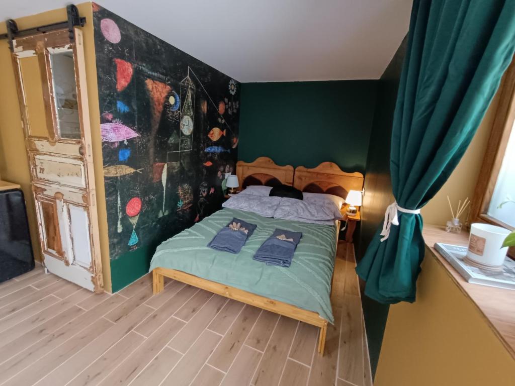 a bedroom with a bed with a painting on the wall at Porta Green in Budapest