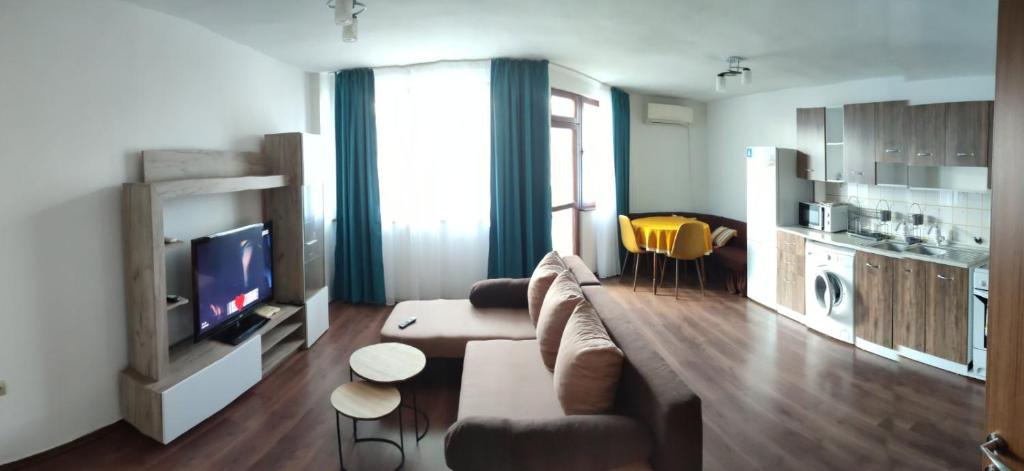 a living room with a couch and a tv at Eleny home in Burgas City