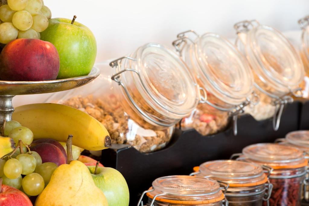 a display of fruits and vegetables and jars of food at La Bastide de Biot in Biot