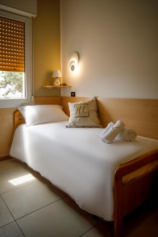 A bed or beds in a room at Hotel Hc Resort Lignano