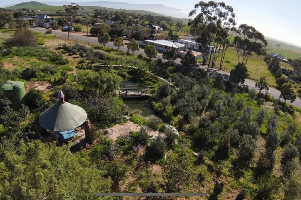 an aerial view of a farm with trees and a road at Koringberg siding cottage in Koringberg