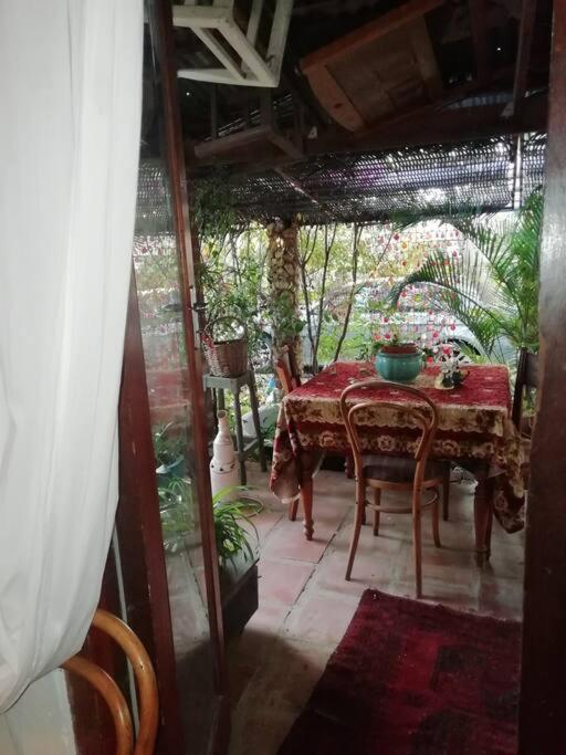 a table and chairs on a porch with a table at Koringberg siding cottage in Koringberg
