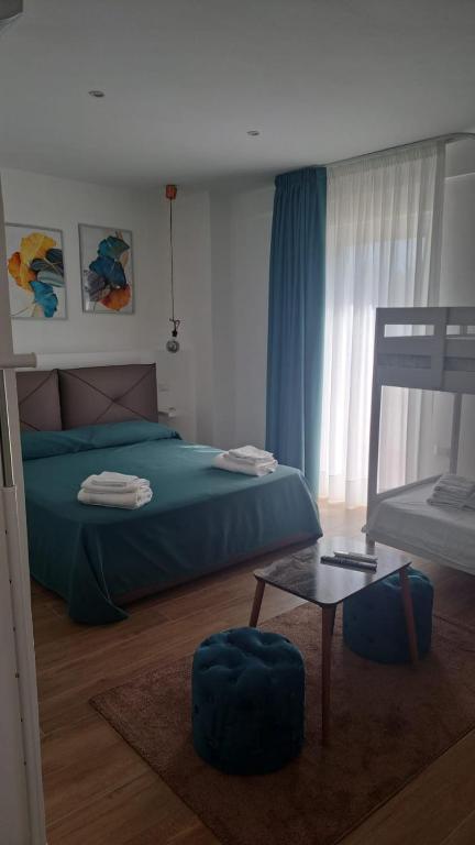 a bedroom with a blue bed and a table at Nànnì guest home in Pozzovetere