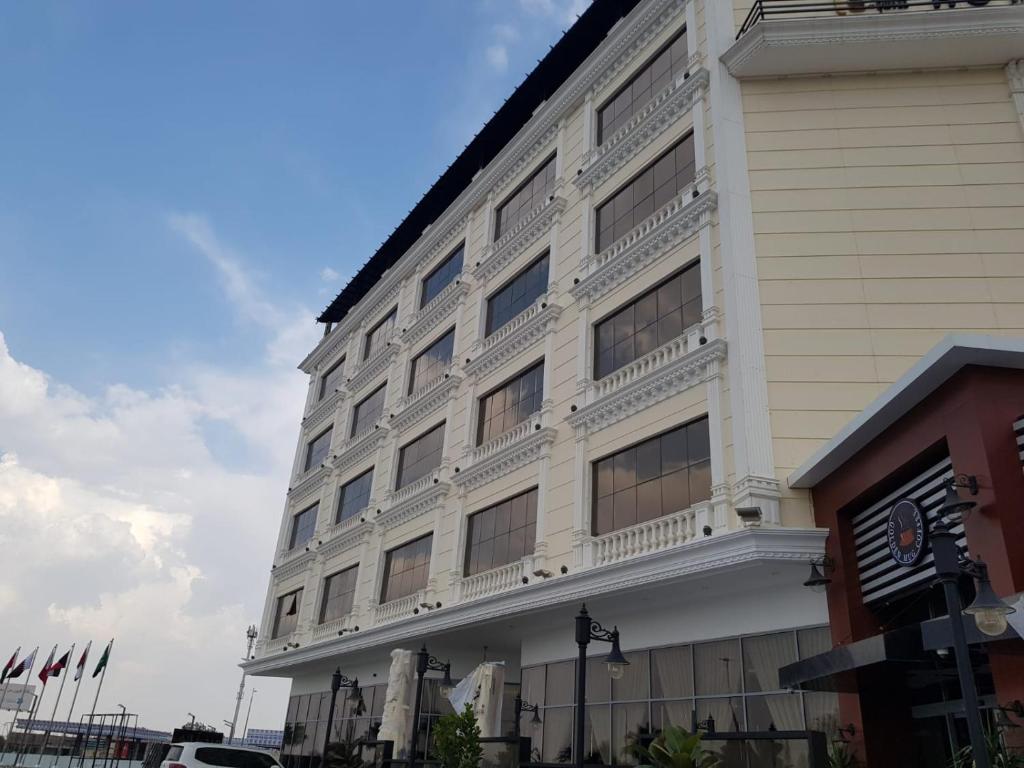 a large white building with a lot of windows at STwin Hotel in Abha