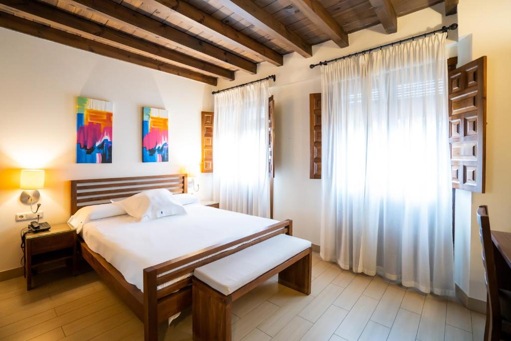 a bedroom with a large bed and a window at YIT Abentofail in Guadix