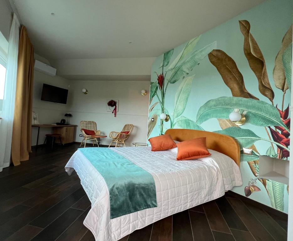 a bedroom with a bed with a mural on the wall at Le Finestre Sul Lago in Cesenatico