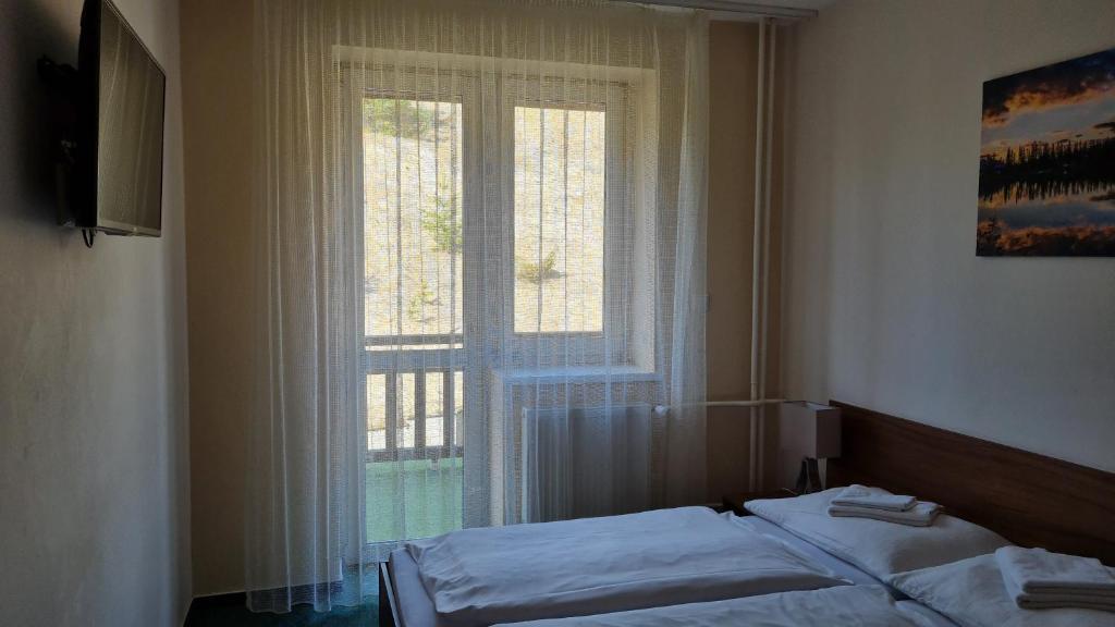 Postel nebo postele na pokoji v ubytování Hotel Sipox