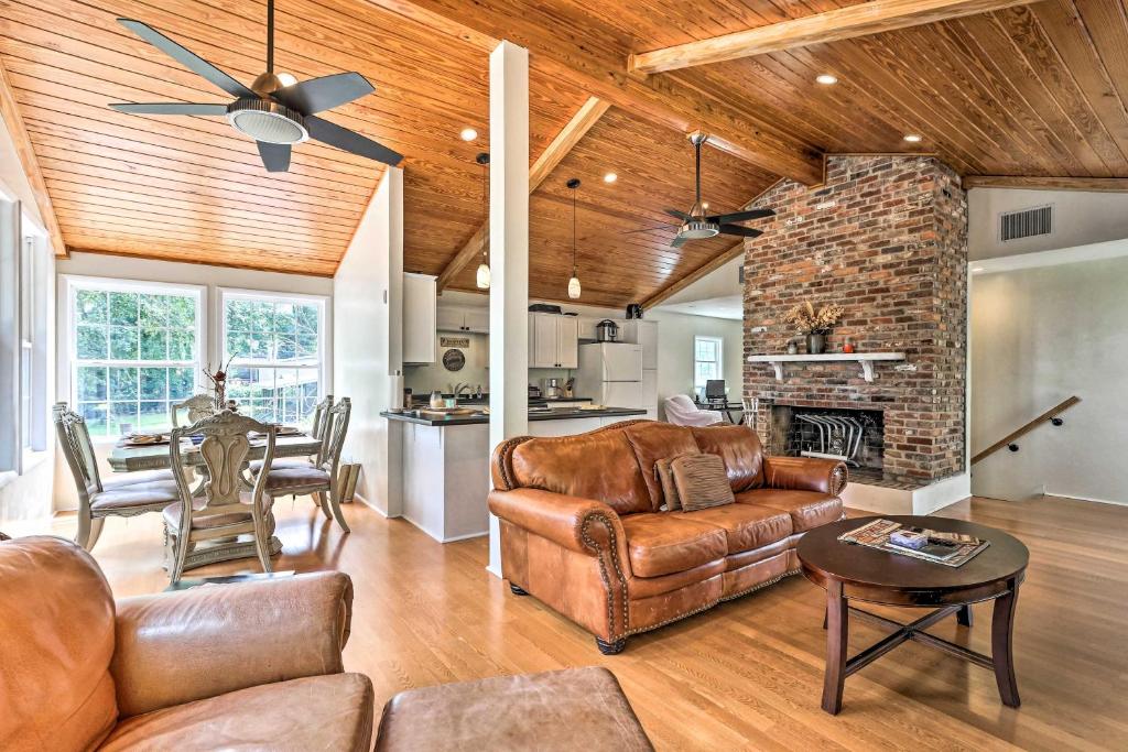 a living room with leather furniture and a fireplace at Spacious Family Home on Lake Marion with Boat Ramp! 