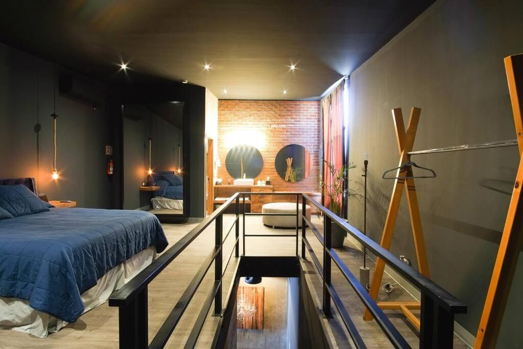 a bedroom with a bed on a balcony at Brand New Gorgeous Industrial Loft in Downtown Ens in Ensenada
