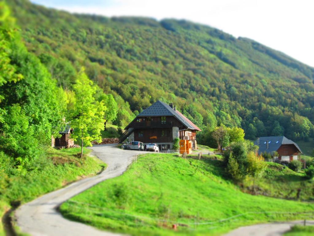 uma casa numa colina ao lado de uma estrada em La Grangerie em Aillon-le-Jeune