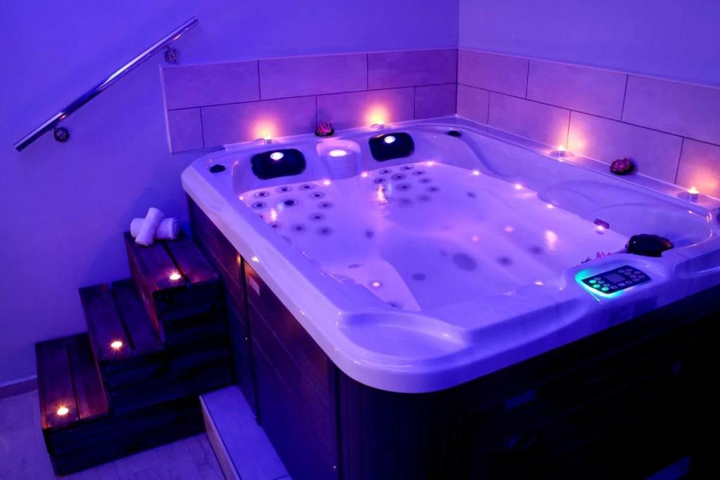 a large bath tub with lights in a bathroom at Nefelifamilyhouse with jacuzzi in Lagonissi