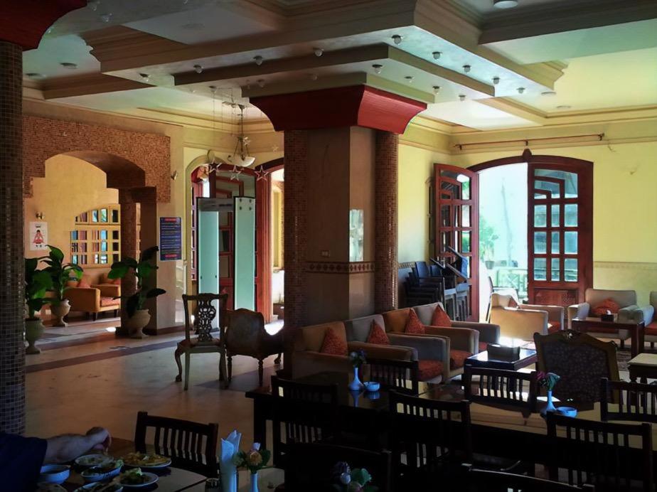 a lobby with a couch and tables and chairs at Salvatore Room with Breakfast-Ras El Bar in Ras El Bar