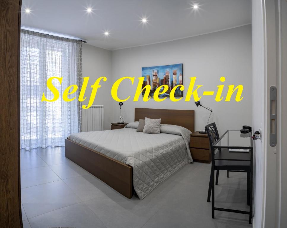 a bedroom with a bed with the words self check in at Damè in Salerno