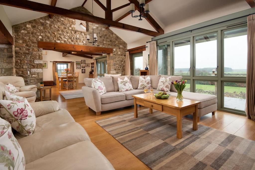 a living room with a couch and a table at East Lodge in Bedale