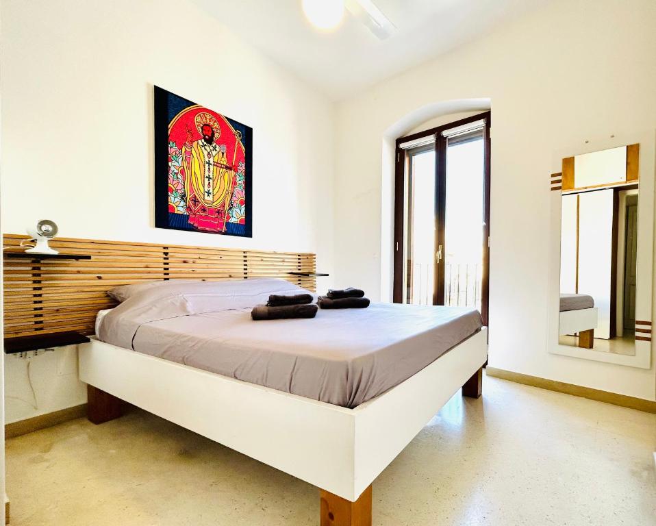 a bedroom with a large bed in a room at Santa Scolastica Home in Bari