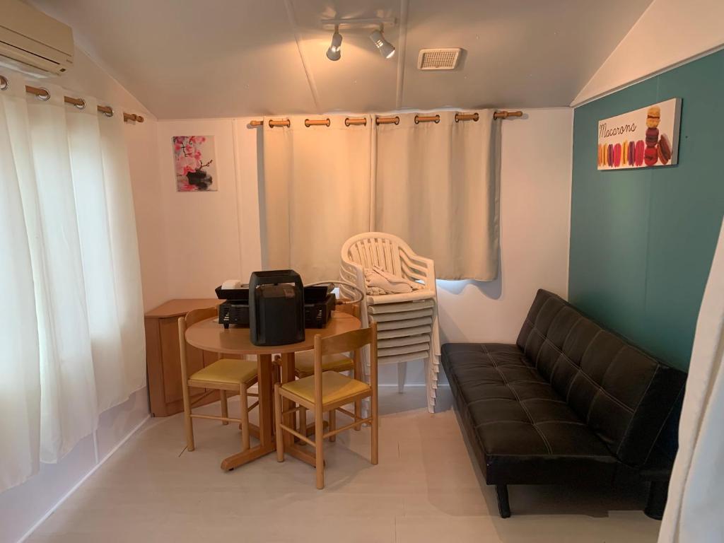a living room with a table and a couch at SABLE D OR in Le Grau-dʼAgde
