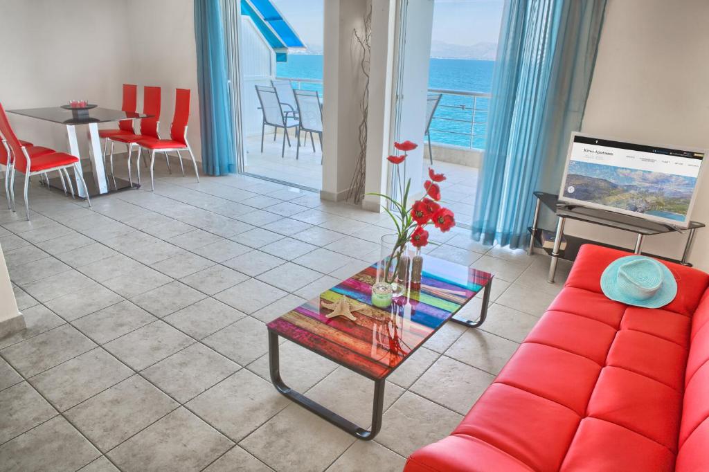 a living room with a red couch and a table at Kiveri Apartments in Kiveri