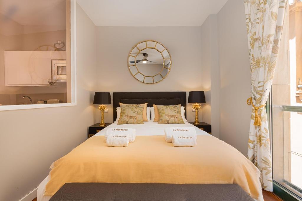 a bedroom with a large bed with two towels on it at C31 Deluxe Apartment into Cathedral Square in Málaga