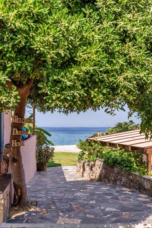 un albero con un passaggio che conduce alla spiaggia di Malsova Studio a Kotrónion