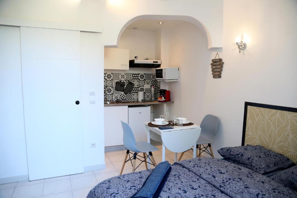 a bedroom with a bed and a table and chairs at PLUTON in Saint-Quentin