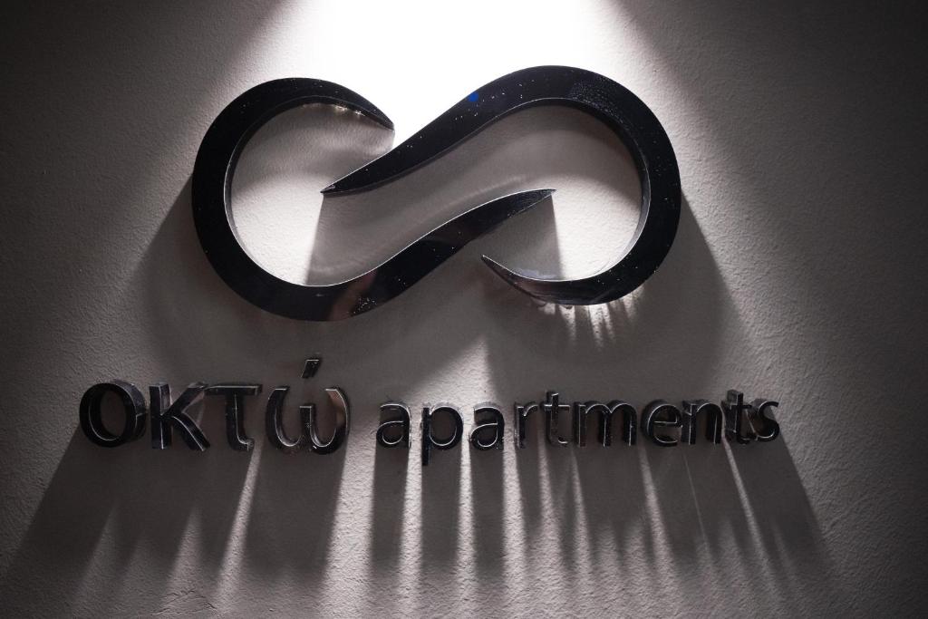 a sign on a wall with the words otiki apartments at Oktò apartments Milazzo in Milazzo