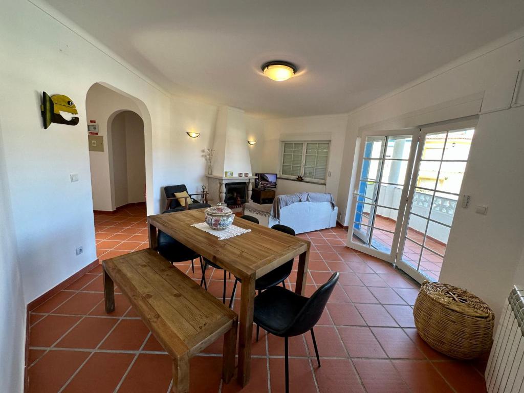 a living room with a wooden table and a bedroom at Best Houses 91 - Casa D'el Rey in Amoreira