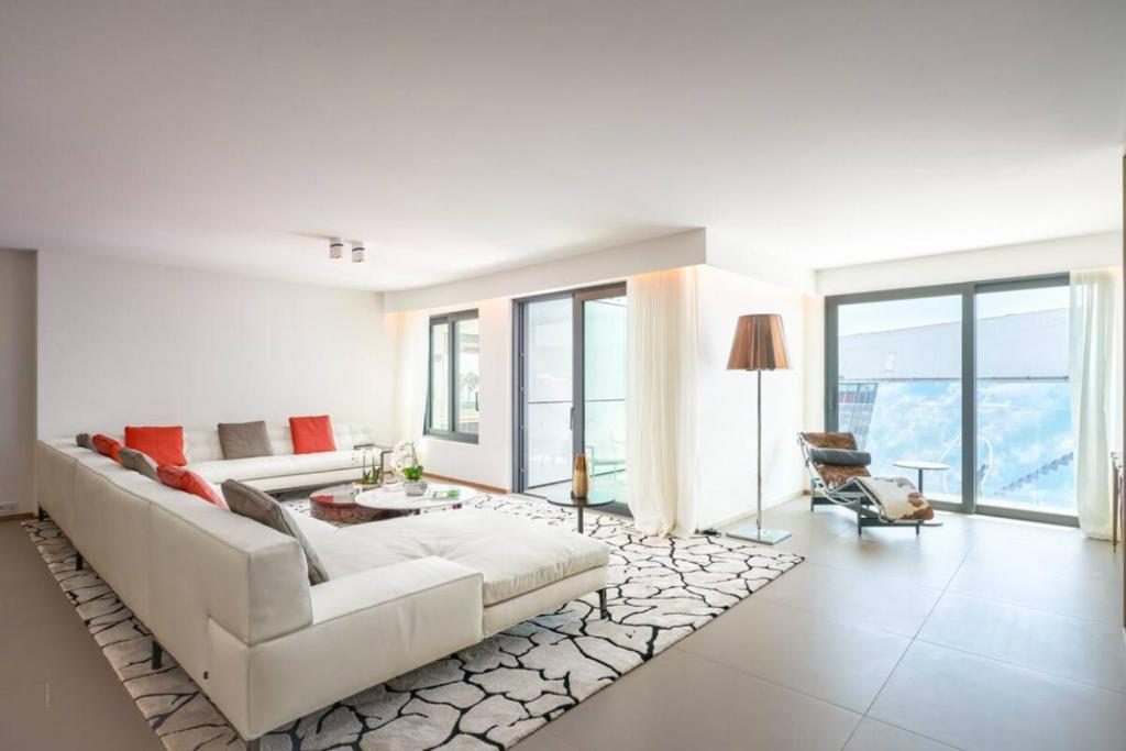 Sala de estar blanca con sofá blanco y alfombra en Luxurious 3BR6p apartment with terrace - First Croisette Cannes 602 en Cannes