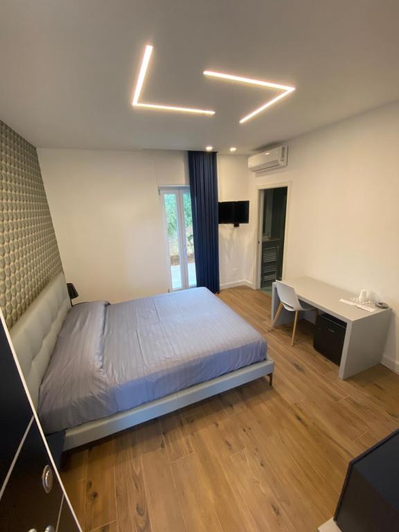 a bedroom with a bed and a desk and a desk at Villa Palladino B&B in Santo Spirito