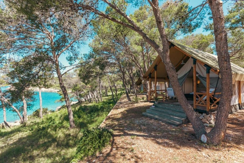 a cabin with a view of the water at Obonjan Island Resort in Šibenik