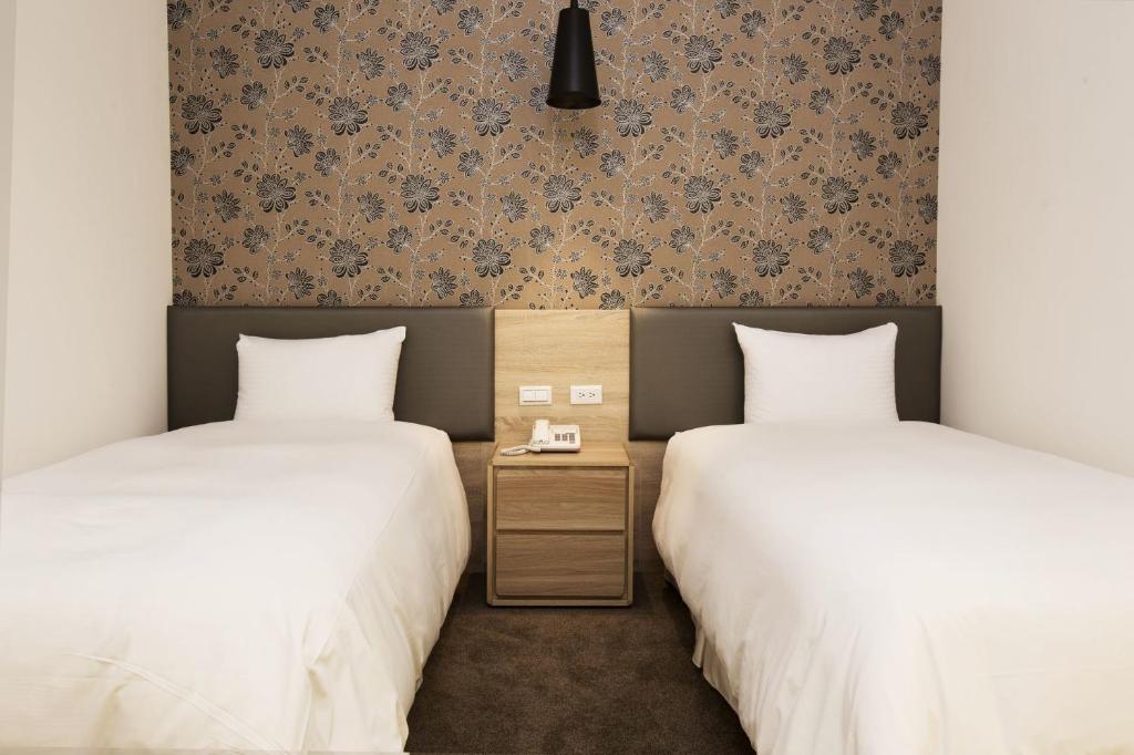 Postel nebo postele na pokoji v ubytování Queens Hotel II