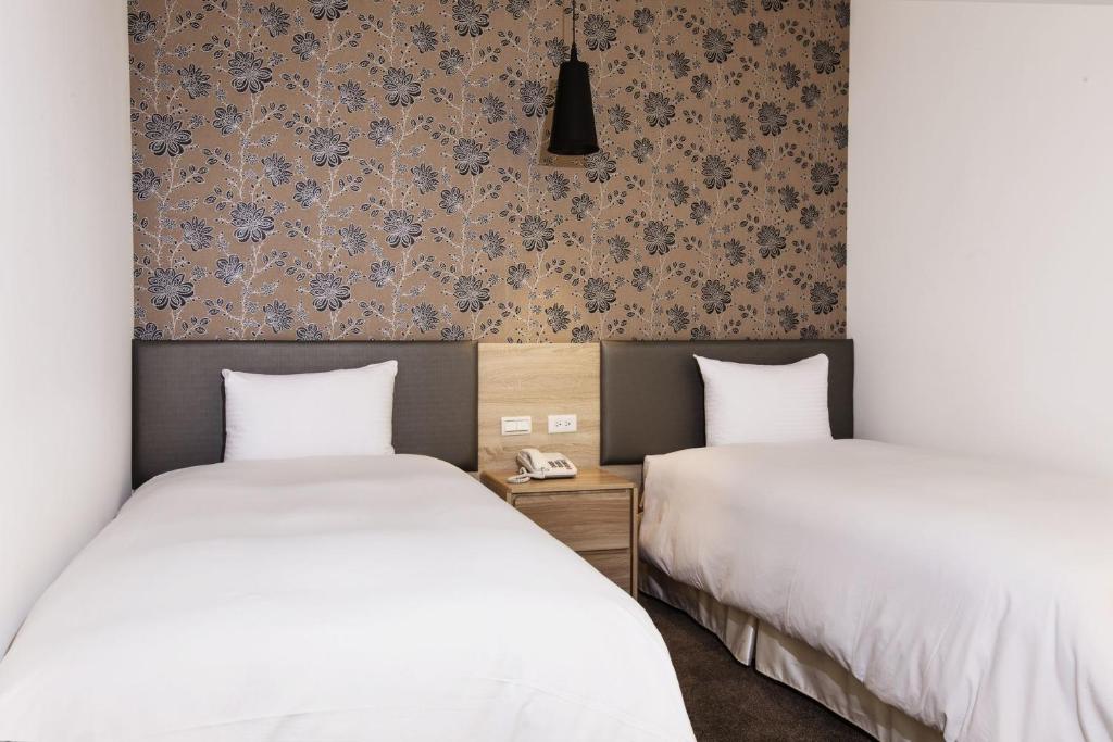 Postel nebo postele na pokoji v ubytování Queens Hotel II