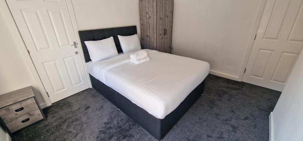 a small bedroom with a bed with a white blanket at APARTMENT IN CENTRAL BARNSLEY in Barnsley