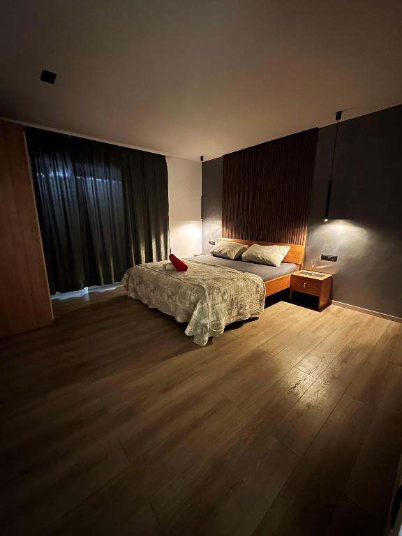 a bedroom with a bed with a red book on it at Partners Perfect Place in Brela