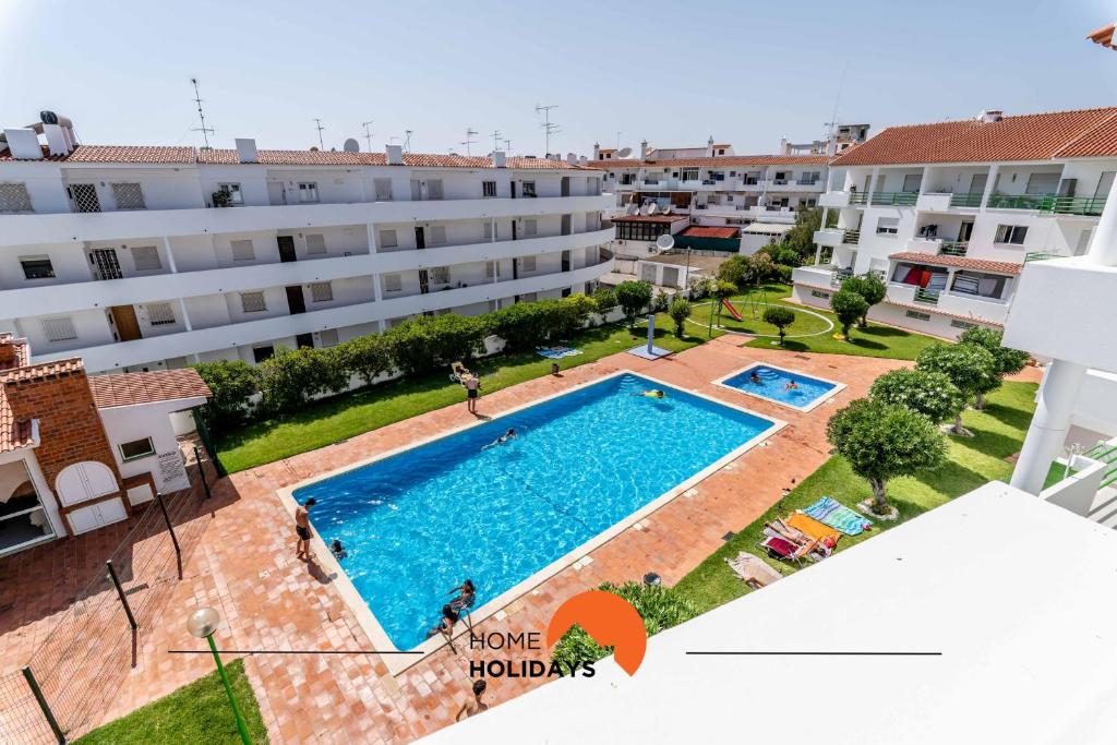 an apartment with a large swimming pool in a building at #167 Santa Eulália by Home Holidays in Branqueira