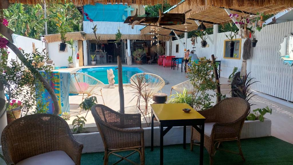 patio ze stołem i krzesłami oraz basenem w obiekcie Baan sikhao Yanui w mieście Rawai Beach