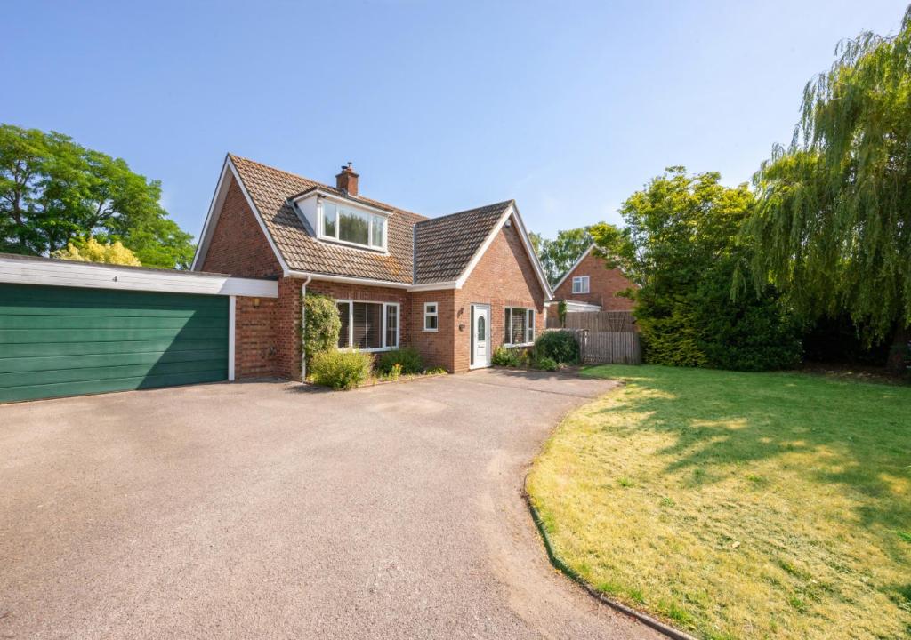 a house with a driveway and a garage at The Willows in Bromeswell