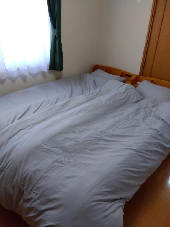 Gulta vai gultas numurā naktsmītnē Restful Tsukuda - Vacation STAY 14830