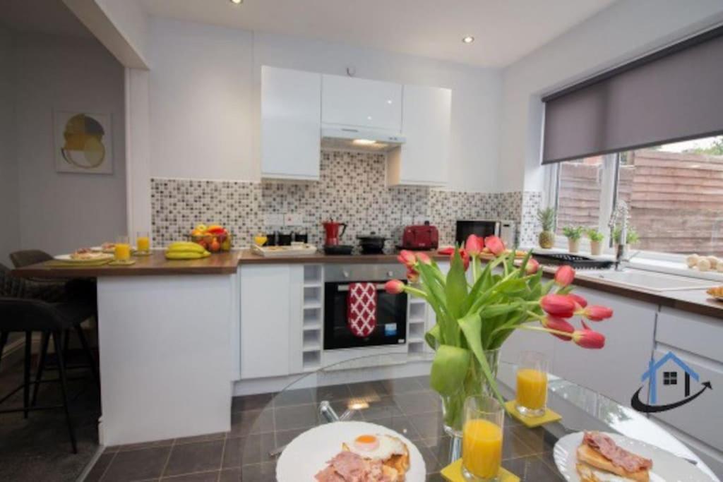 a kitchen with a table with a plate of food on it at Wheatley Casa, 3 bed, driveway, workspace, wifi, corporates,pets in Doncaster